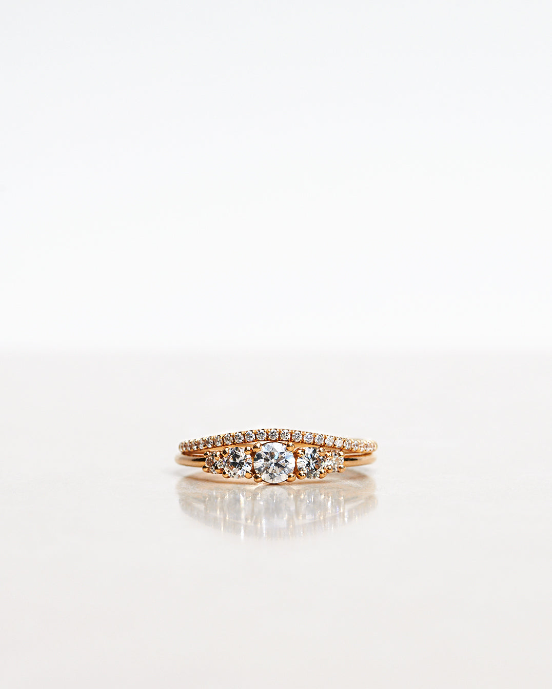 Ring stack with two Mumbaistockholm Fine Jewelry Rings:  Elise Ring in 18K yellow gold with five white, conflict-free diamonds and Jade Petite Wave Half Ring with a curved band half covered with 0.005 CT diamonds TWVS.